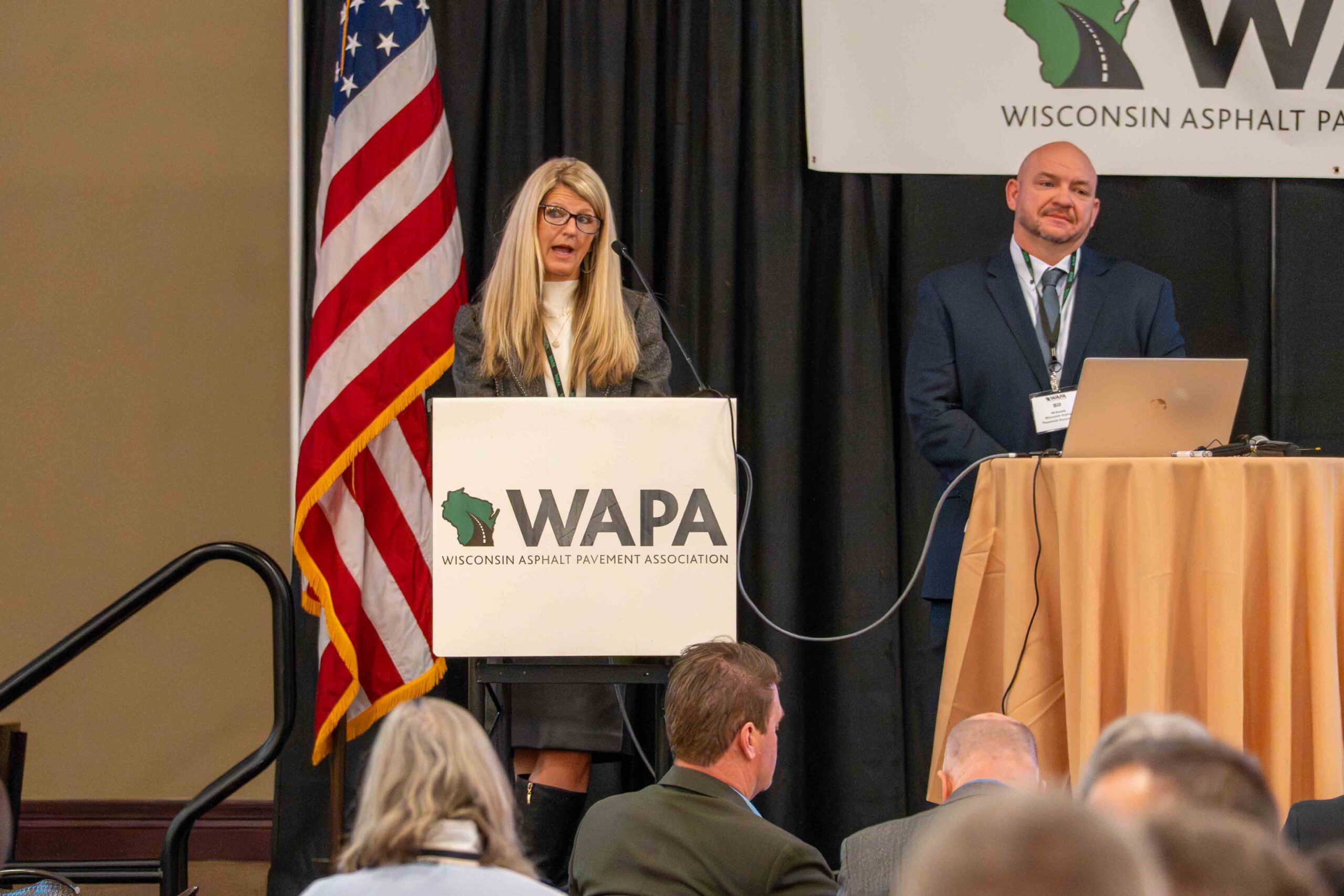 A woman speaking at a podium during a conference